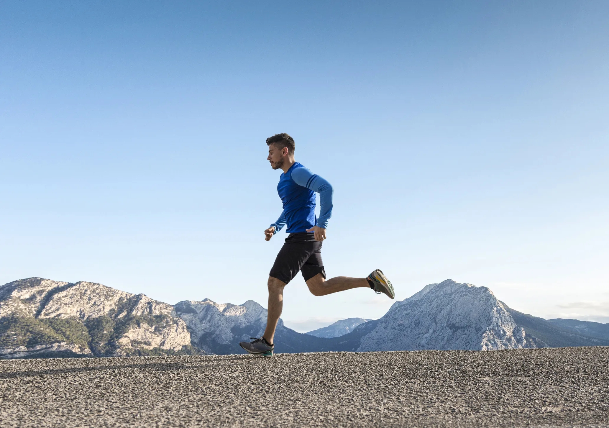 Image of a dedicated runnermid-stride, emphasizing the role of L-lysine ...